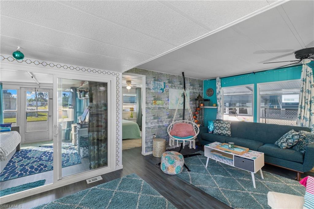 43 Enchanting Boulevard, Unit E43 Naples, FL 34112 - Photo 18 of 36 a living room with furniture and a table
