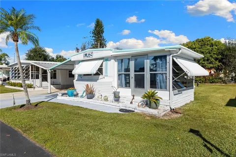 a view of a house with backyard porch and sitting area