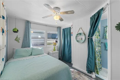 a bedroom with a bed dresser and a window