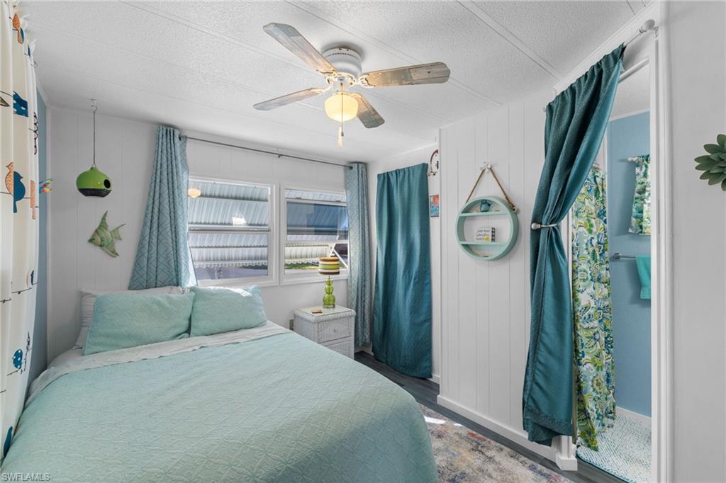 43 Enchanting Boulevard, Unit E43 Naples, FL 34112 - Photo 22 of 36 a bedroom with a bed dresser and a window