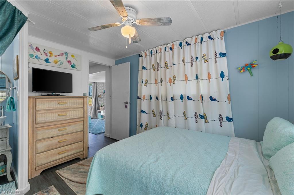 43 Enchanting Boulevard, Unit E43 Naples, FL 34112 - Photo 24 of 36 a bedroom with a bed and a flat screen tv