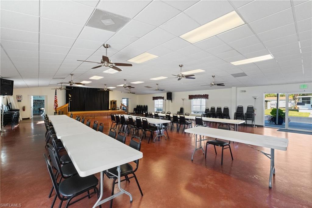 43 Enchanting Boulevard, Unit E43 Naples, FL 34112 - Photo 32 of 36 a living room with lots of furniture and a large mirror