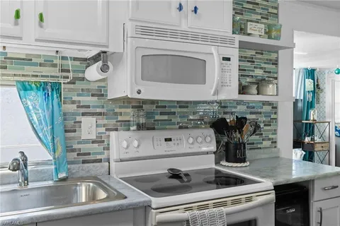 a close view of a sink a faucet and appliance in the kitchen