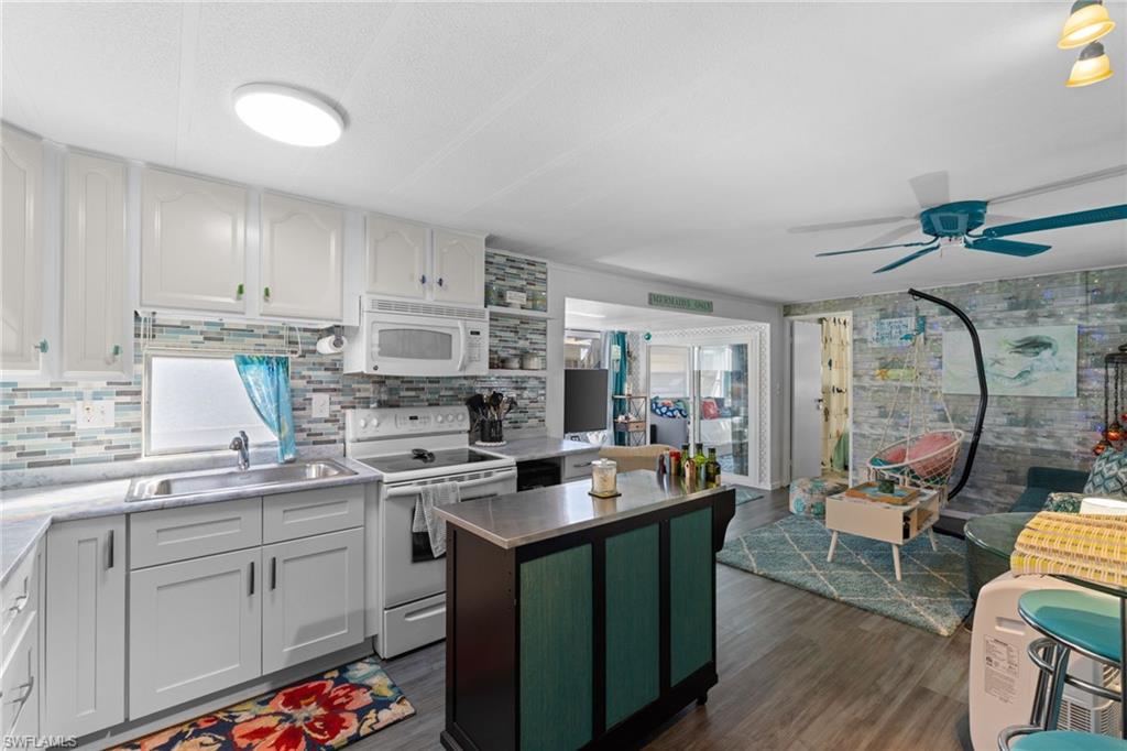 43 Enchanting Boulevard, Unit E43 Naples, FL 34112 - Photo 7 of 36 a kitchen with a sink stove and cabinets