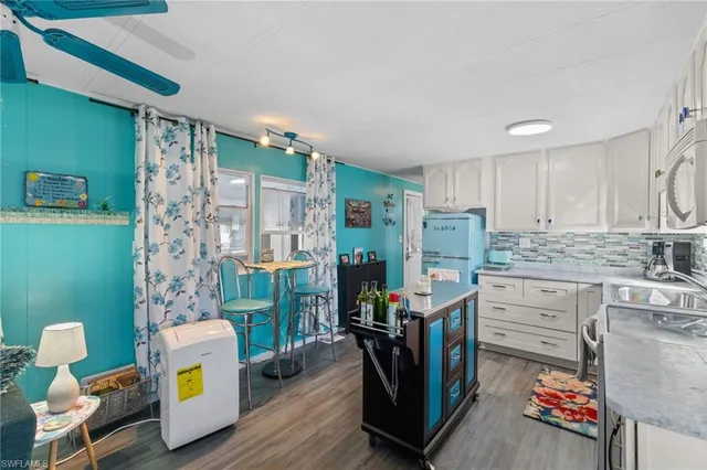 a kitchen with refrigerator and cabinets