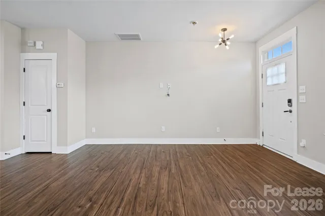 an empty room with wooden floor