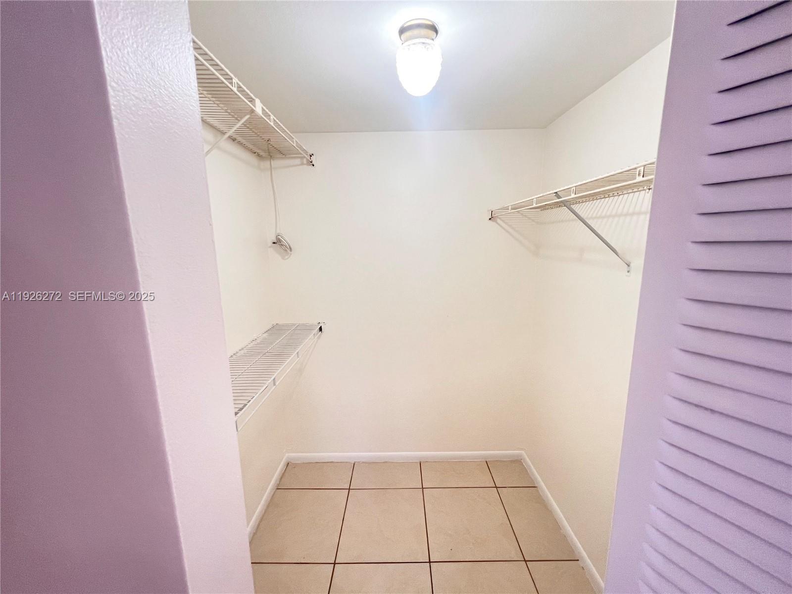 7801 South Colony Circle, Unit 201 Tamarac, FL 33321 - Photo 5 of 10 a view of an empty walk in closet