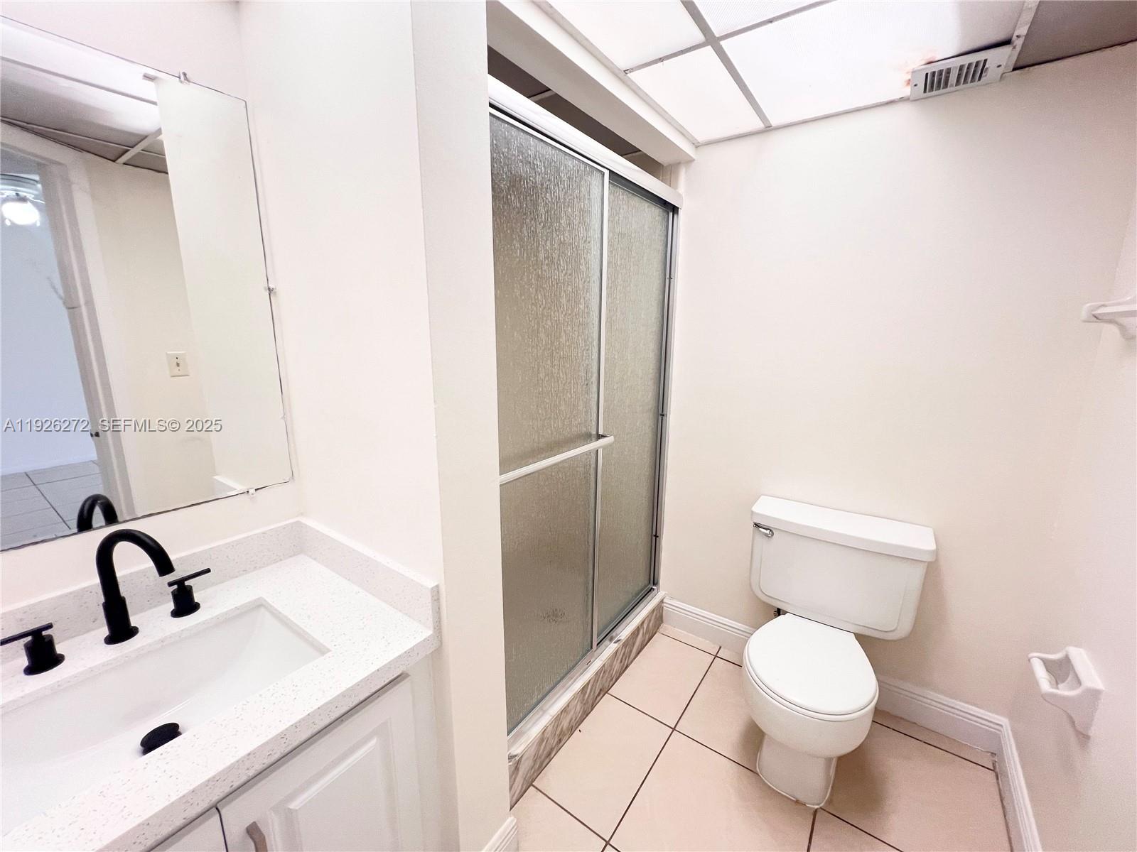 7801 South Colony Circle, Unit 201 Tamarac, FL 33321 - Photo 7 of 10 a bathroom with a sink toilet and shower