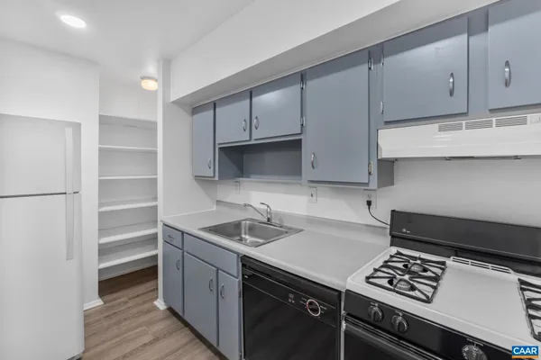 a kitchen with a sink appliances and cabinets