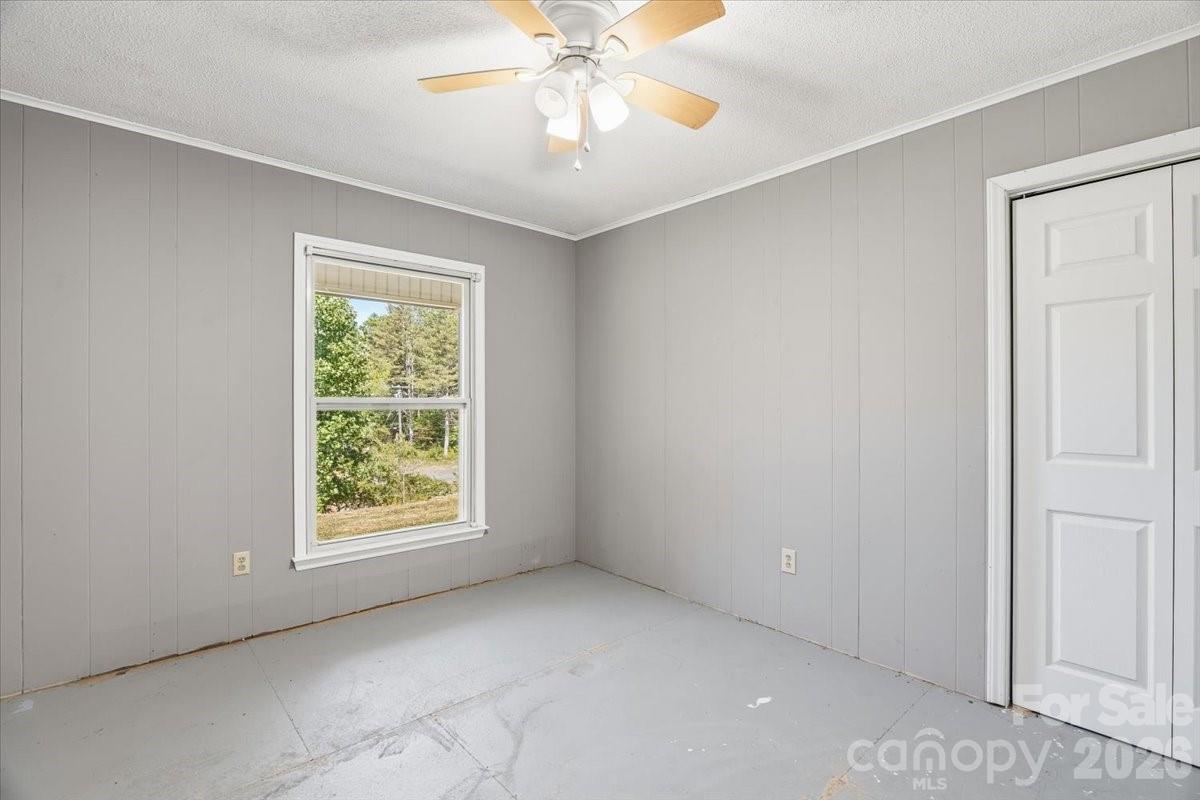 14 Jack Sullins Road Spruce Pine, NC 28777 - Photo 22 of 37 an empty room with windows and fan
