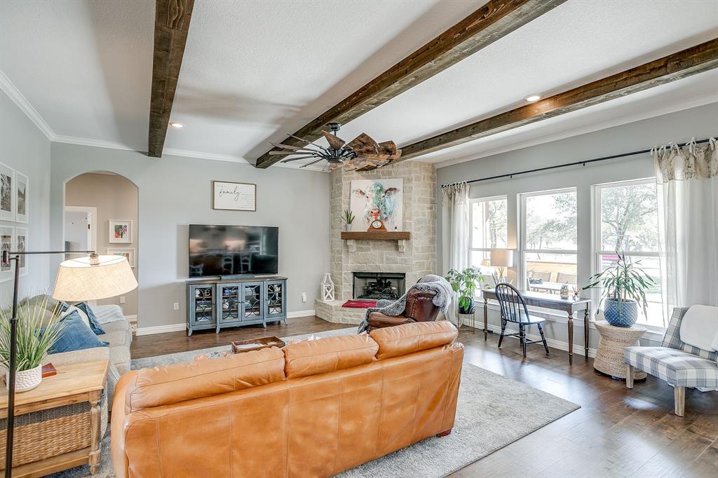 229 Oak Tree Drive Poolville, TX 76487 - Photo 13 of 40 a living room with fireplace furniture and a flat screen tv