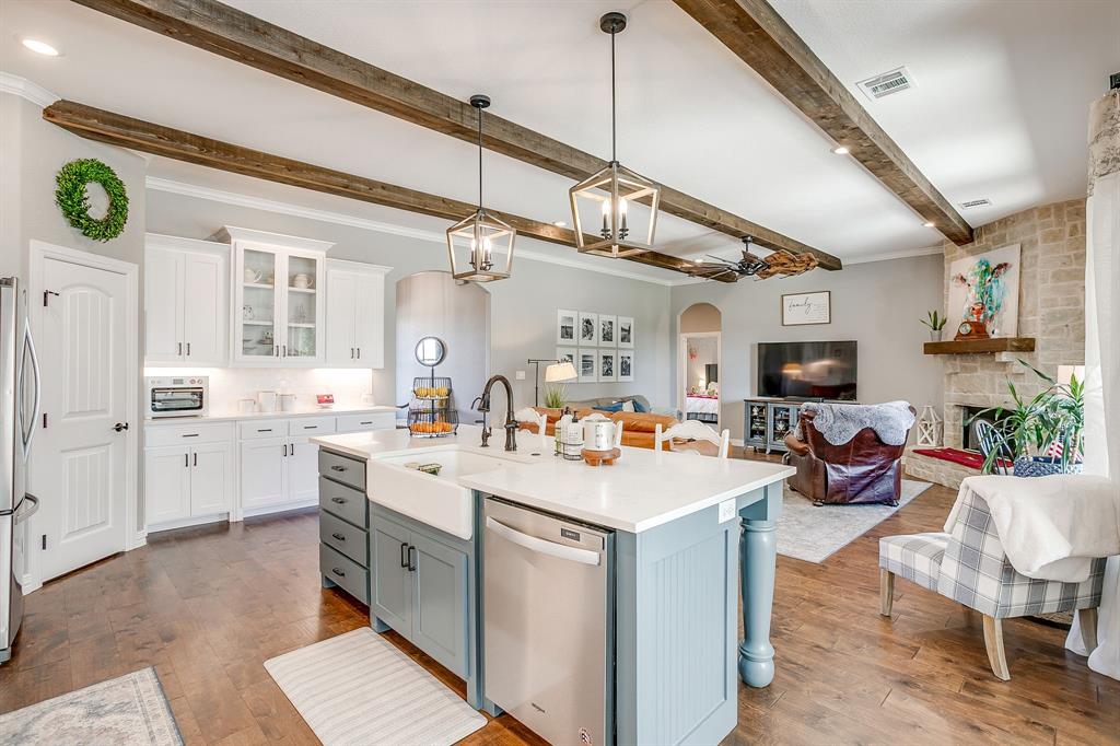 229 Oak Tree Drive Poolville, TX 76487 - Photo 14 of 40 a kitchen with a sink cabinets and wooden floor
