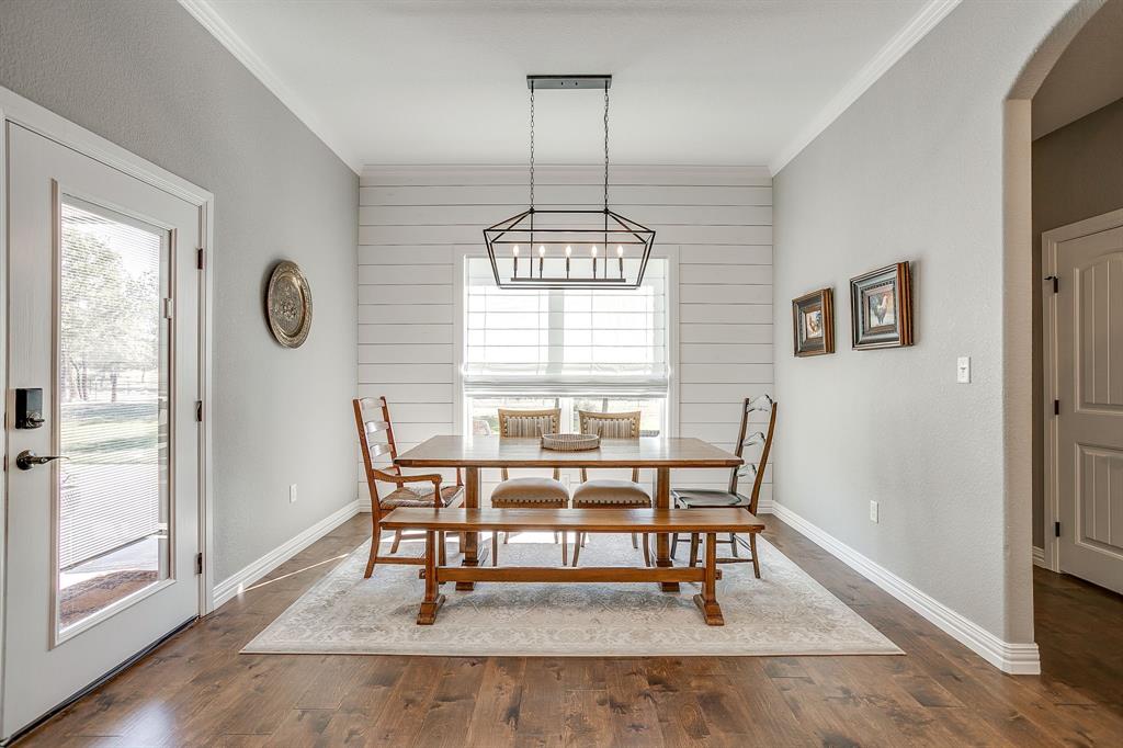 229 Oak Tree Drive Poolville, TX 76487 - Photo 17 of 40 a view of a dining room with furniture window and wooden floor