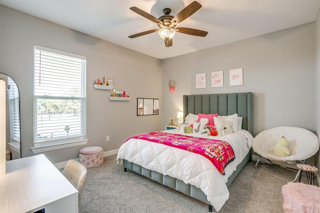 229 Oak Tree Drive Poolville, TX 76487 - Photo 24 of 40 a bedroom with a bed and a window