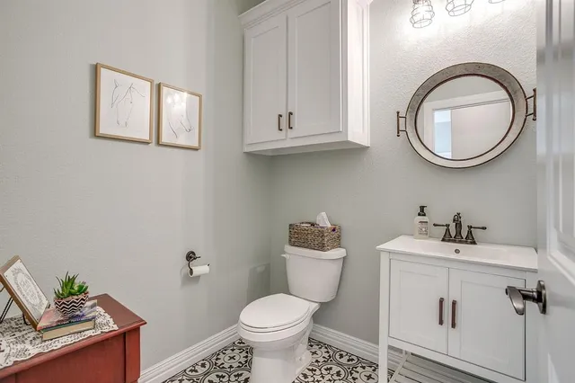 a bathroom with a toilet sink and mirror
