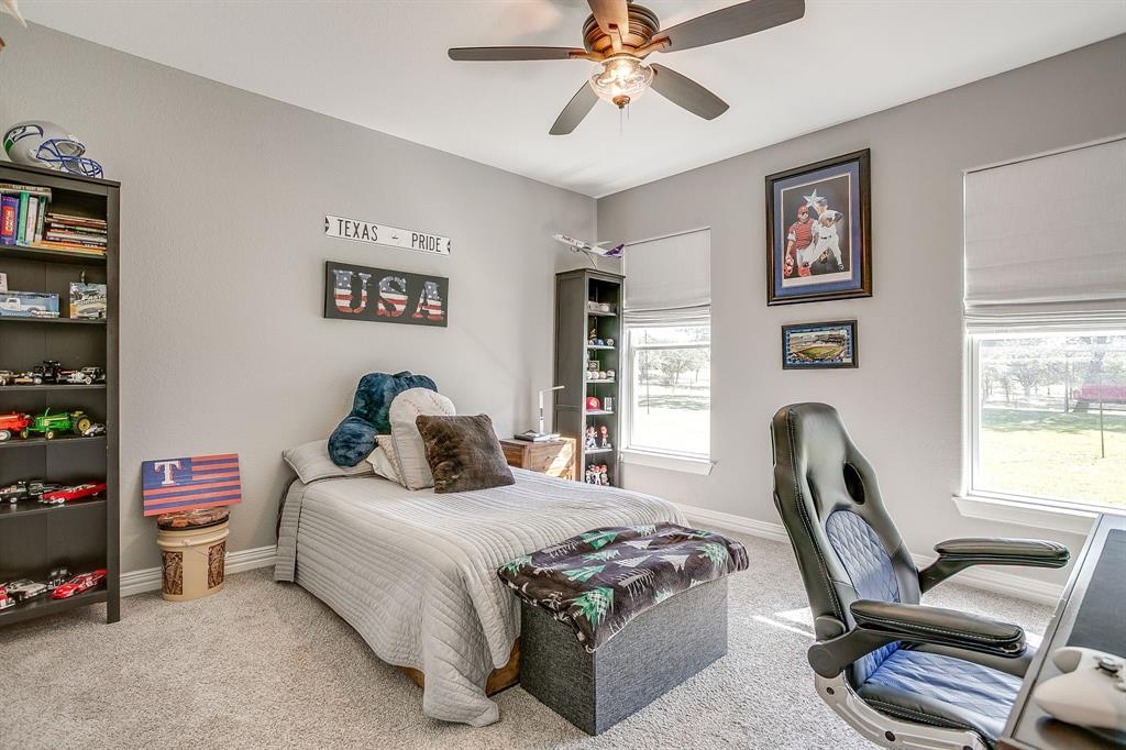 229 Oak Tree Drive Poolville, TX 76487 - Photo 26 of 40 a bedroom with a bed a couch and a window