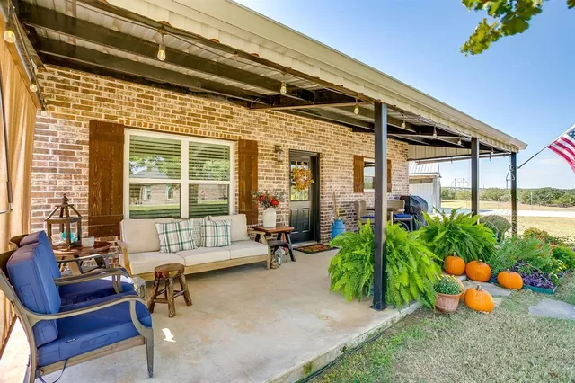 a backyard of a house with outdoor seating