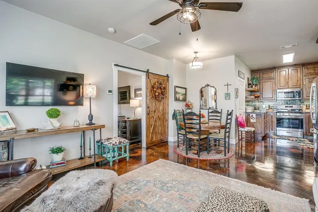 a very nice looking living room with stainless steel appliances furniture