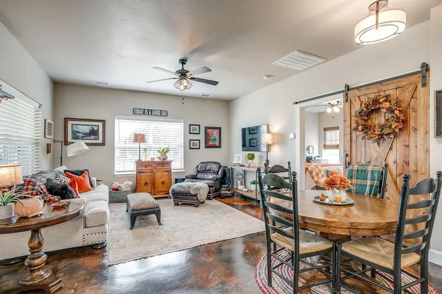 a living room with furniture dining area and a window