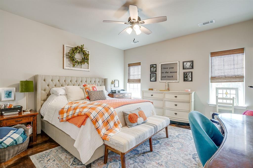 229 Oak Tree Drive Poolville, TX 76487 - Photo 34 of 40 a bedroom with a bed and wooden floor