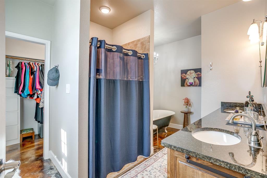 229 Oak Tree Drive Poolville, TX 76487 - Photo 35 of 40 a bathroom with a sink double vanity and a mirror