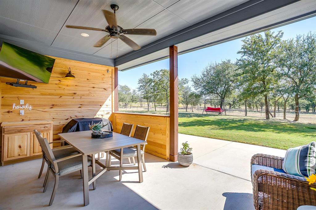 229 Oak Tree Drive Poolville, TX 76487 - Photo 37 of 40 a view of a porch with furniture and a yard