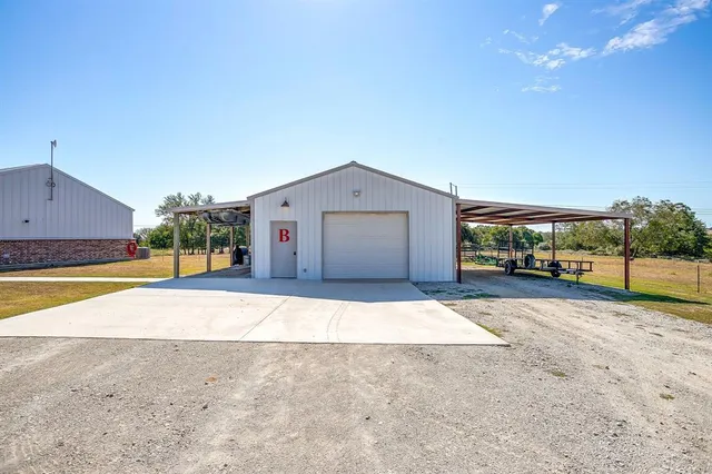 a view of house with swimming pool and yard