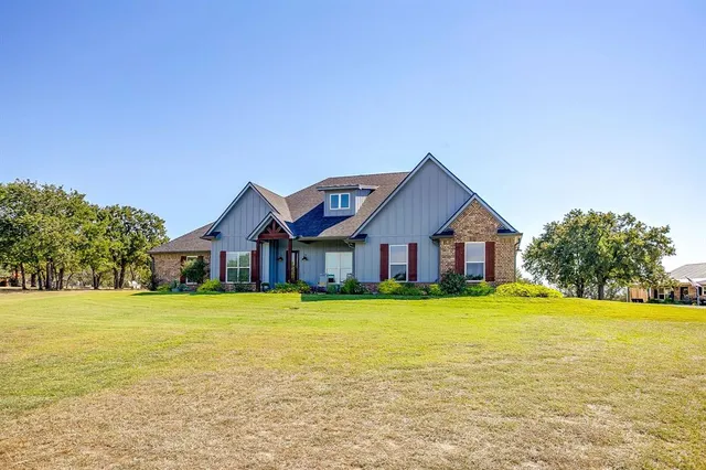a front view of house with yard and green space