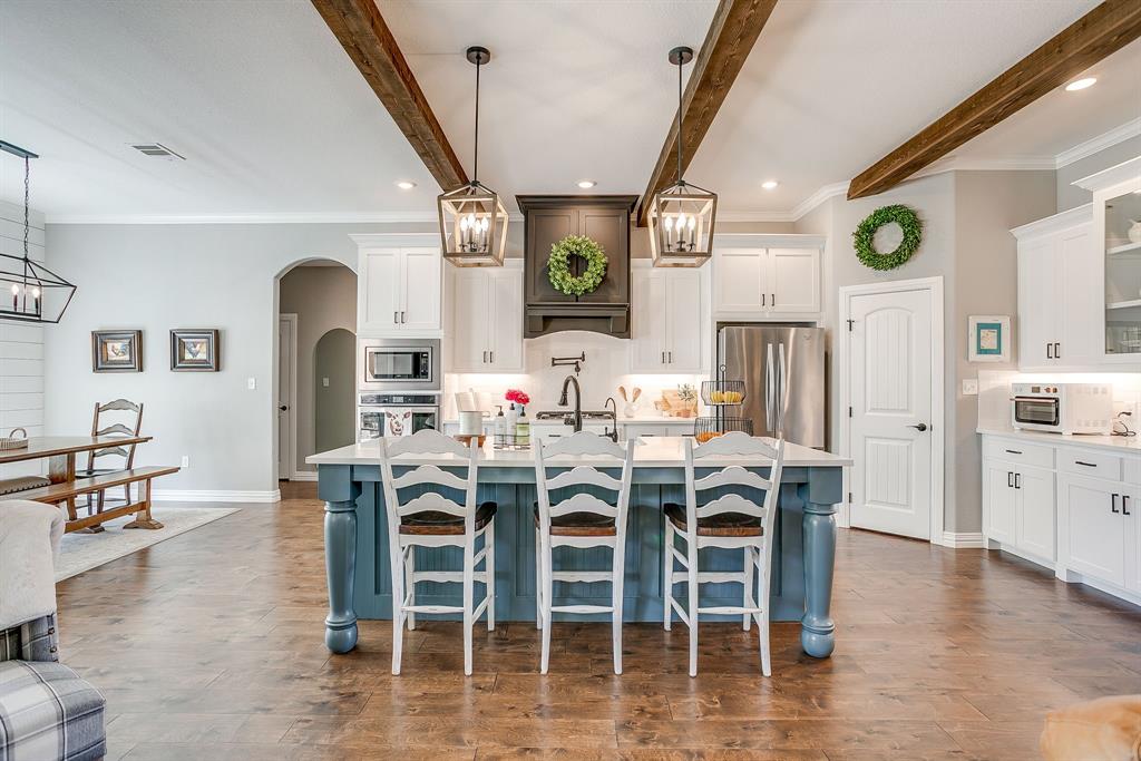 229 Oak Tree Drive Poolville, TX 76487 - Photo 8 of 40 a view of a dining room with furniture window and wooden floor