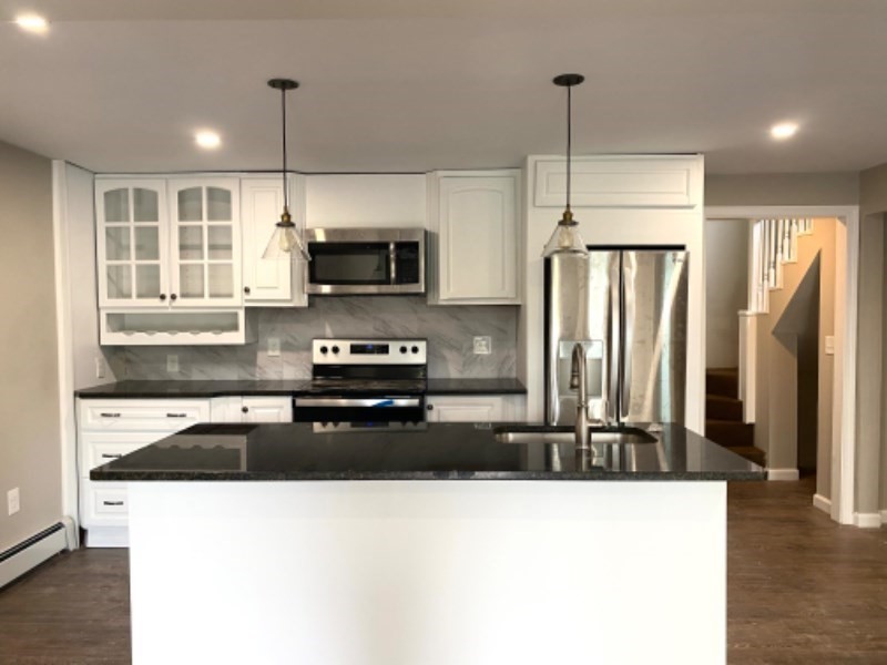 205 West Street, Unit 3 Walpole, MA 02081 - Photo 1 of 12 a kitchen with stainless steel appliances granite countertop a refrigerator a stove and a sink with wooden floor
