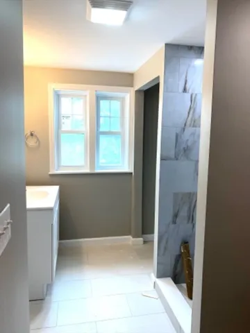 a bathroom with a tub shower and sink