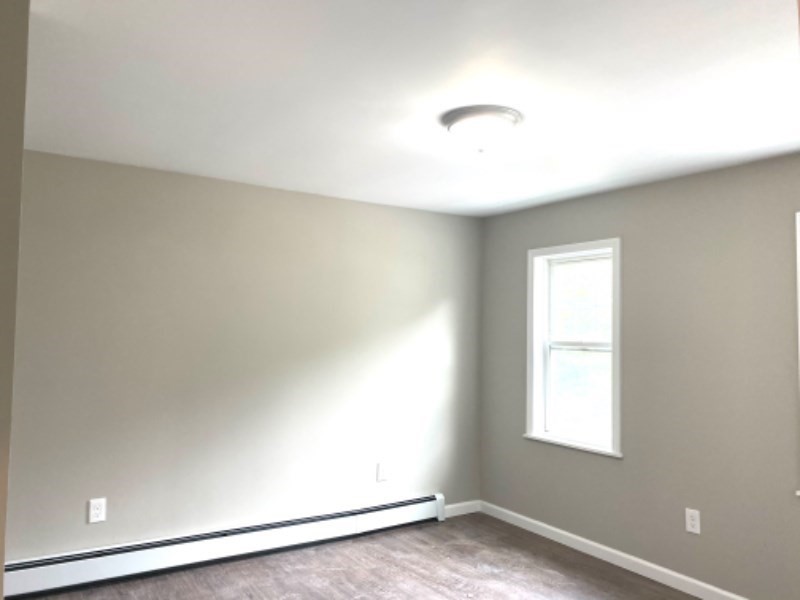 205 West Street, Unit 3 Walpole, MA 02081 - Photo 5 of 12 an empty room with wooden floor and windows