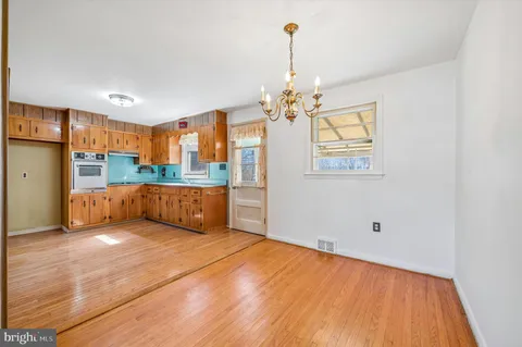 a view of a kitchen with a sink and cabinets