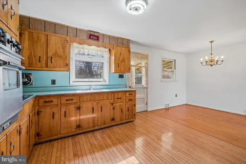 a kitchen with cabinets a window and appliances
