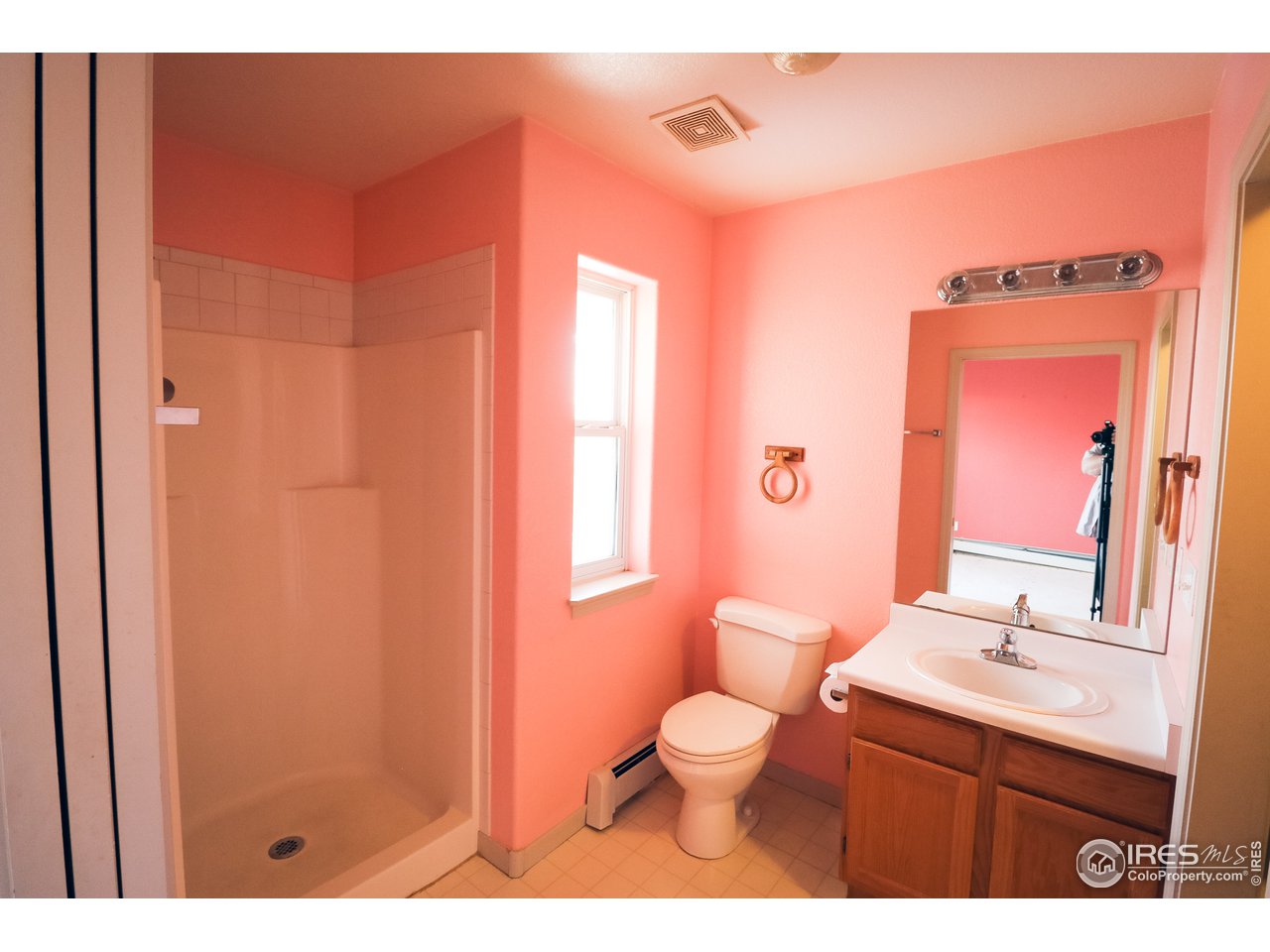 230 South 3rd Street Berthoud, CO 80513 - Photo 12 of 22 a bathroom with a sink a toilet and a mirror
