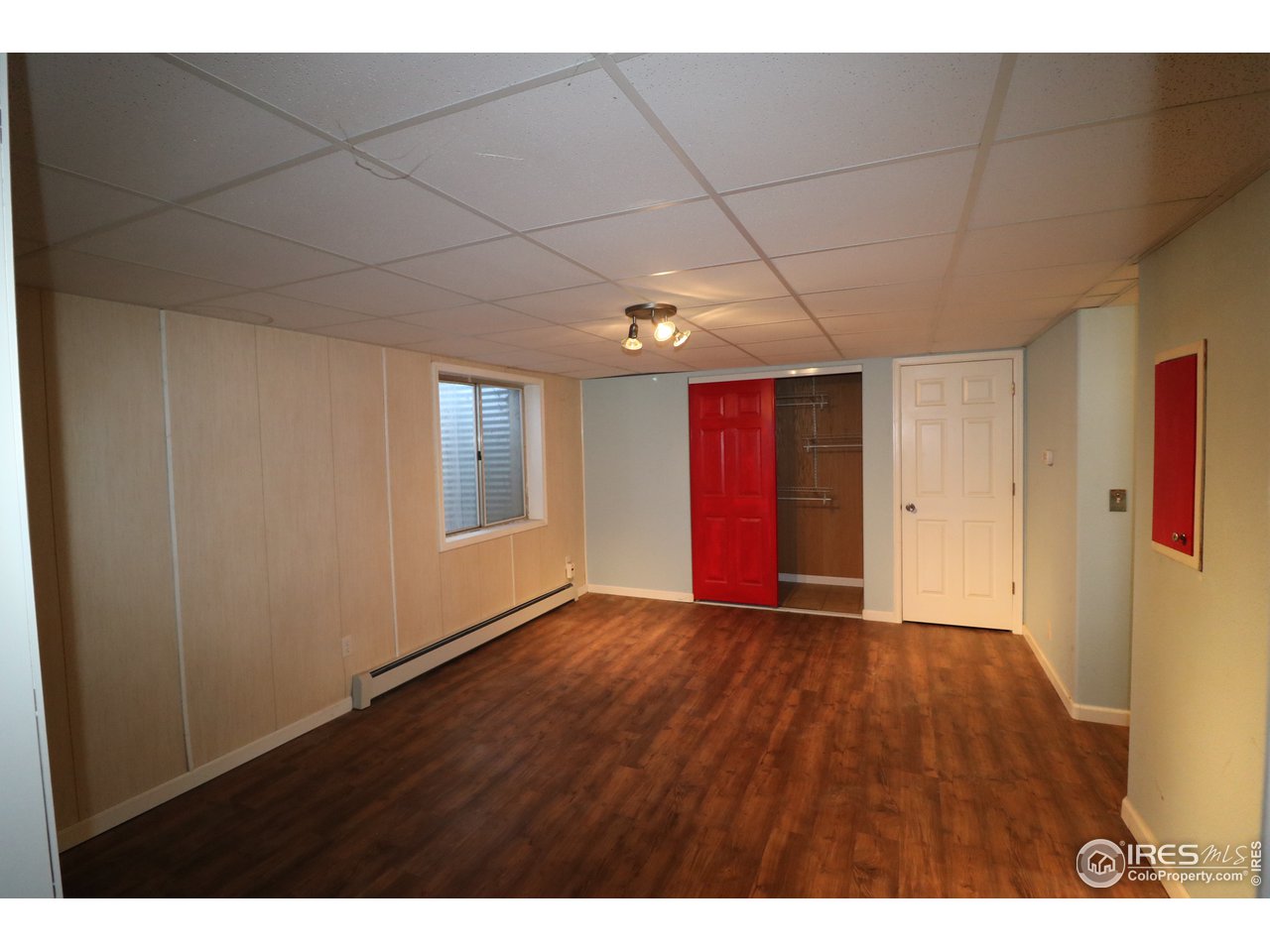 230 South 3rd Street Berthoud, CO 80513 - Photo 16 of 22 a view of an empty room with window and wooden floor