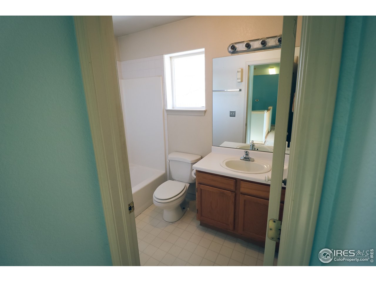 230 South 3rd Street Berthoud, CO 80513 - Photo 10 of 22 a bathroom with a sink a toilet and a mirror