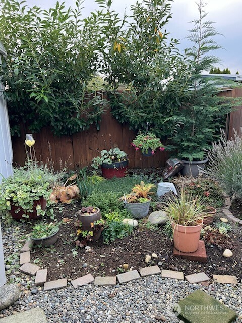 3702 Hunt Street, Unit 23 Gig Harbor, WA 98335 - Photo 17 of 17 a garden with lots of trees