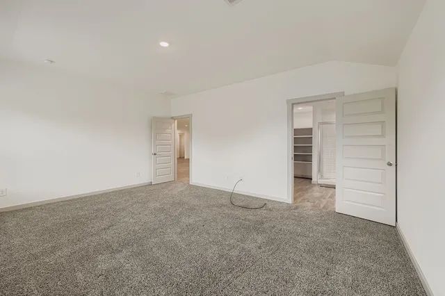 a view of an empty room with a closet