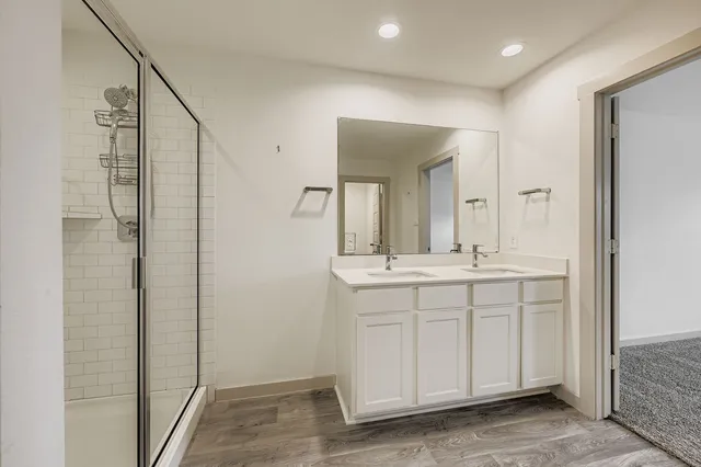 a bathroom with a double vanity sink and a mirror