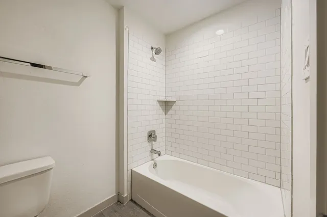 a bathroom with a bathtub and shower
