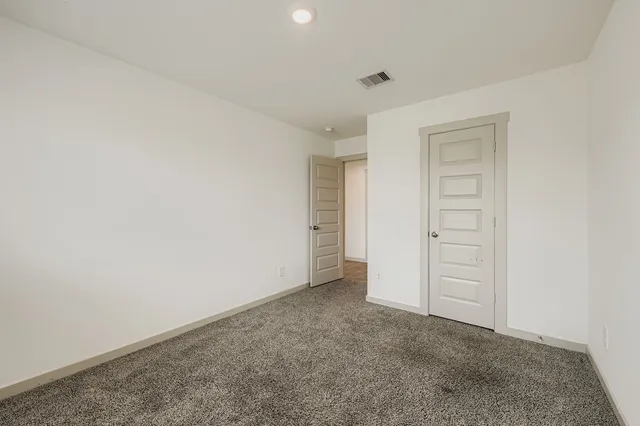 an empty room with closet area
