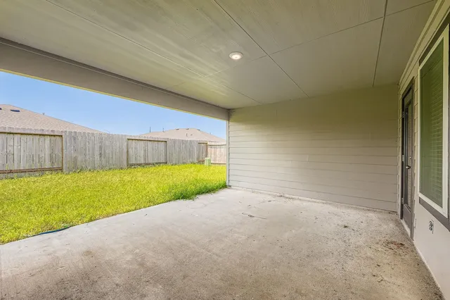 a view of a backyard with wooden fence