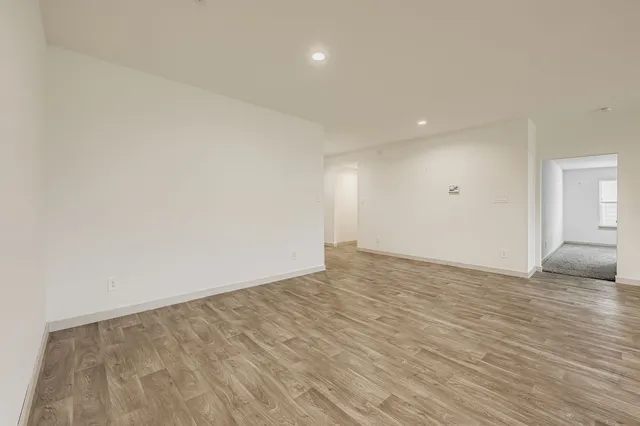 a view of an empty room and wooden floor