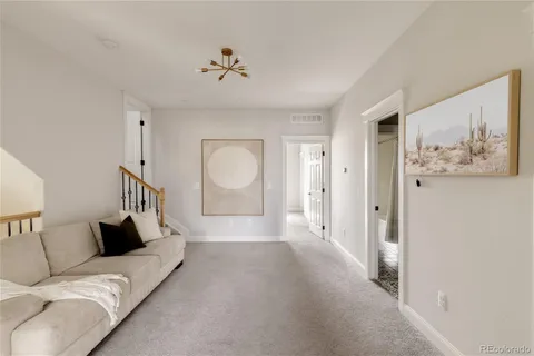 a living room with furniture and a mirror