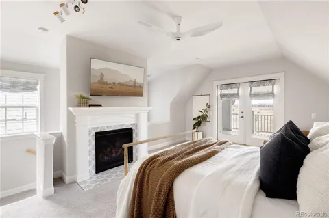 a bedroom with a bed and a fireplace