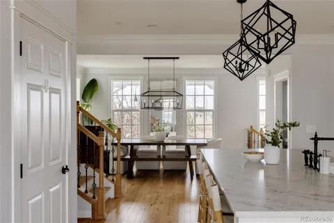 a dining room with furniture entryway and wooden floor