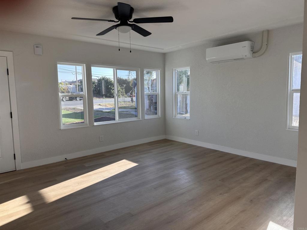 5412 Cervantes Avenue San Diego, CA 92114 - Photo 3 of 28 a view of an empty room with wooden floor and a window