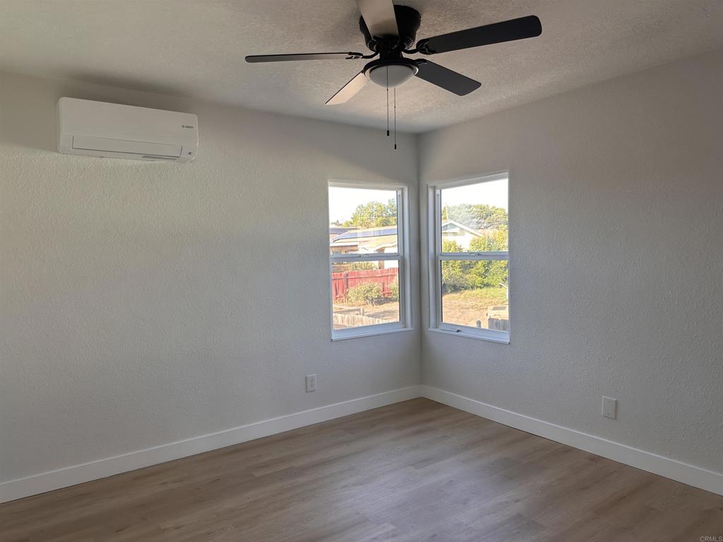 5412 Cervantes Avenue San Diego, CA 92114 - Photo 5 of 28 an empty room with a window and a fan