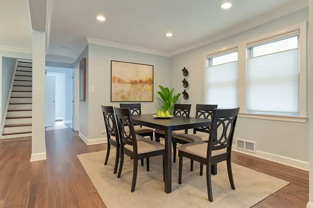 a view of a dining room with furniture and wooden floor